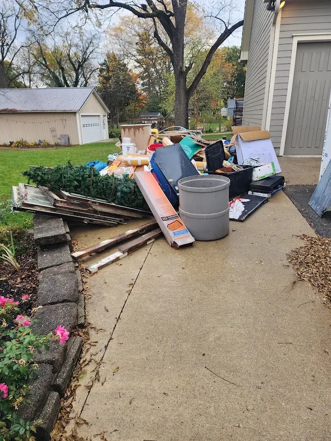 Dumpster being loaded with debris for Roofing Dumpster Rental in Flora